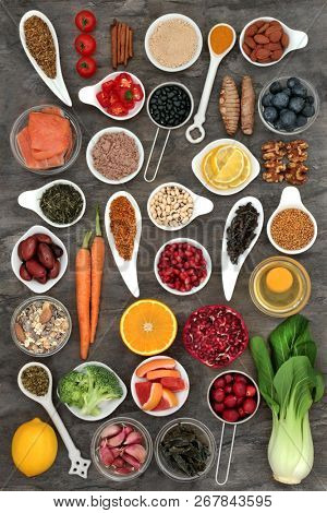 Food selection to slow the ageing process concept with superfoods very high in antioxidants, anthocyanins, dietary fibre and vitamins. Top view on marble background.