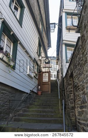 Monschau, Germany, October 2018 - Picturesque Buildings And Narrow Steep Stepped Alley In The Histor