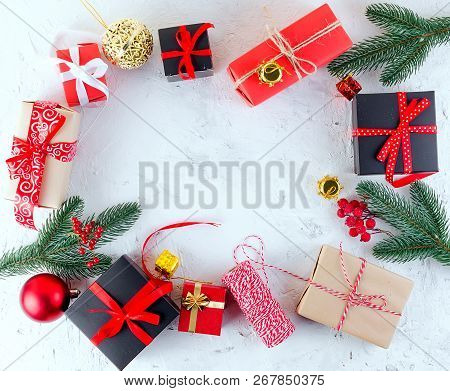 Christmas Decorative Background With Fir Branches, Cones, Redr And Black Christmas  Gifts, Ball On T