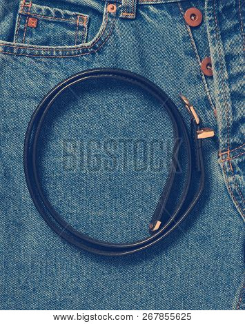 Black Leather Belt On Jeans. Top View. Trend Of Minimalism.