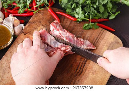 Chef Butcher Cutting Lamb Meat With Knife On Kitchen, Cooking Proteine Food