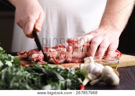 Chef Butcher Cutting Lamb Meat With Knife On Kitchen, Cooking Proteine Food