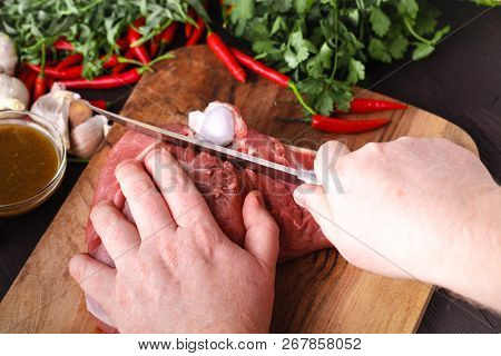 Chef Butcher Cutting Lamb Meat With Knife On Kitchen, Cooking Proteine Food