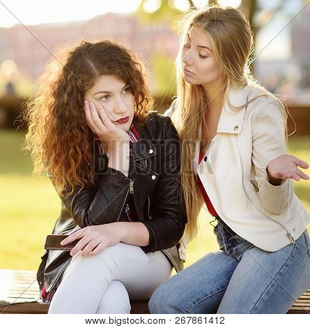Young Woman Support And Soothe Her Upsed Friend. Two Girl During The Conversation. Empathy Concept