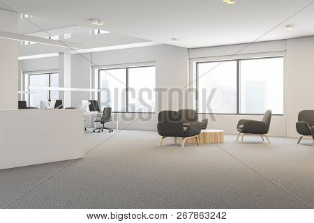Side View Of Office Waiting Area With White Walls, Carpet On The Floor, Round Coffee Table With Gray