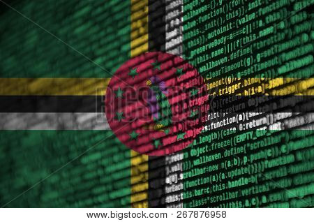 Dominica Flag  Is Depicted On The Screen With The Program Code. The Concept Of Modern Technology And
