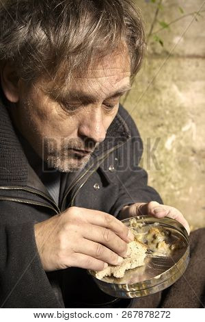 Ugly Pauper Man Living Outdoor Eating Lentil Soup On Street