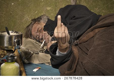 Ugly Pauper Man Living Outdoor Sleeping, Relaxing And Laying Alone On Hidden Urban Place