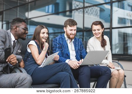 Group Of Happy Diverse Male And Female Business People Team In Formal Gathered Around Laptop Compute
