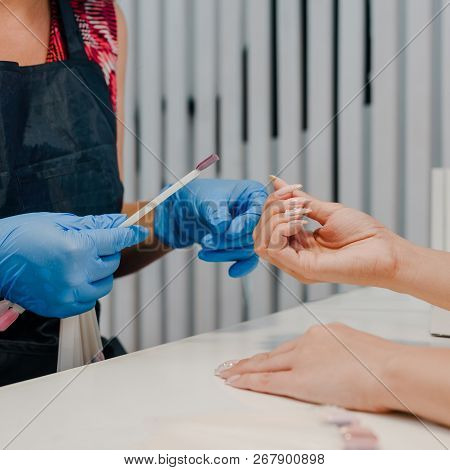 Manicurist Choosing Laquer Color For Her Female Client