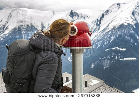 Bettmeralp, Switzerland - May 2017: Man With A Telescope Observing Snowy Alpine View