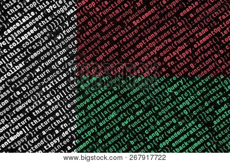 Madagascar Flag  Is Depicted On The Screen With The Program Code. The Concept Of Modern Technology A