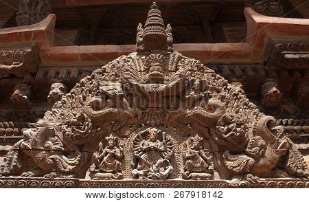Tympanum - Architecture Detail With Ancient Wooden Bas-relief With Hindu God Garuda At Palace On Dur
