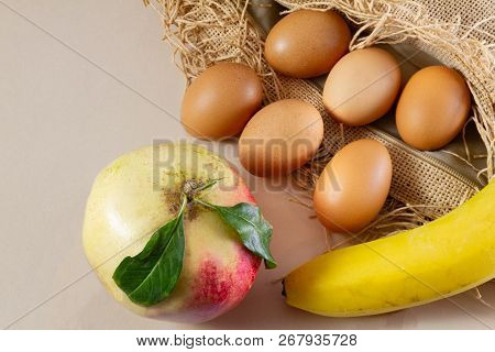Six Eggs One Pomegrenate And One Banana On A Brown Sackcloth (burlap) And White Background- Traditio
