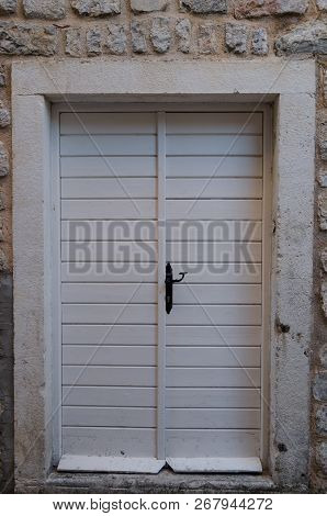 Old Wooden, White The Door Closed On Iron Bolt.on Metal Canopies.