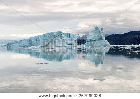 View Of An Iceberg Reflected In The Water, Navigating The Upsala Channel In The Glacier National Par