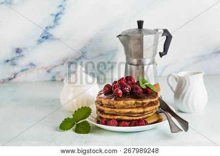 Gluten-free Green Buckwheat Pancakes With Fresh Berries And Maple Syrup. Delicious Vegan Breakfast W