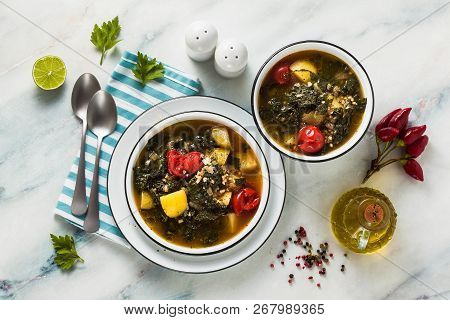 Vegan Winter Kale Soup With Buckwheat , Cherry Tomatoes And Potatoes. Tasty Full Vegetable Food For
