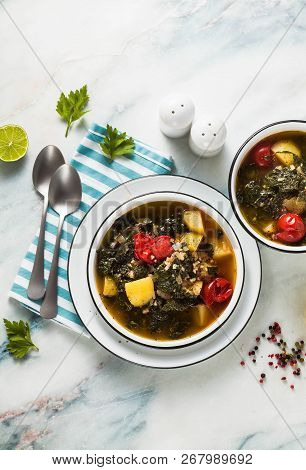 Vegan Winter Kale Soup With Buckwheat , Cherry Tomatoes And Potatoes. Tasty Full Vegetable Food For