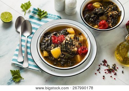 Vegan Winter Kale Soup With Buckwheat , Cherry Tomatoes And Potatoes. Tasty Full Vegetable Food For