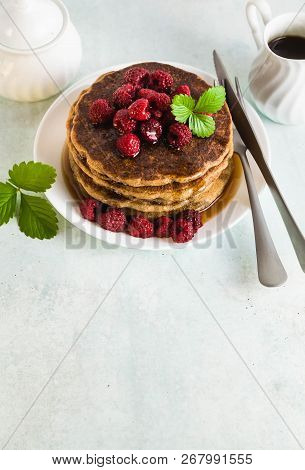 Gluten-free Green Buckwheat Pancakes With Fresh Berries And Maple Syrup. Delicious Vegan Breakfast W