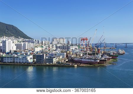 View From Above On Dock With Shipways And Cityscape Of Busan On Sunny Day