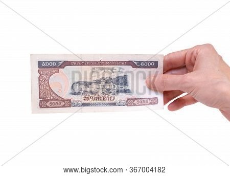 Female Hand Holding A 5000 Kip Banknote Currency Isolated On A White Background. Denomination Of 500