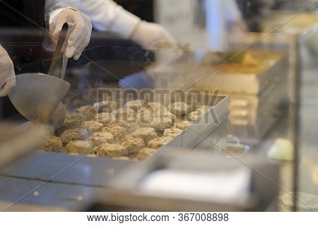Cooking Meatballs On The Grill. Meatballs Are Grilled. Grilled Cutlets. The Cook Fries The Meatballs