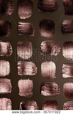Creative brushstrokes of gold paint. Gold paint texture.Acrylic gold paint. Smears of cosmetics, blush, highlighter, eye shadow, lipstick.