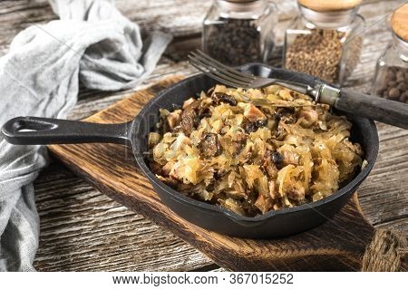 Bigos, A Traditional Polish Dish Of Sauerkraut Served In A Cast Iron Skillet.