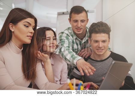 Group Of Young People Studying Together At College Classroom