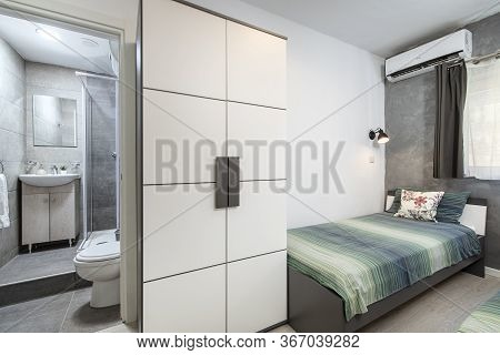 St Julians, Malta - April 28th 2020: Small Twin Bedroom With Turqoise Green Bedding And A Tiny Grey 