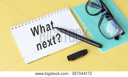 Next Steps Text On Wooden Desk With Tablet Pc And Keyboard