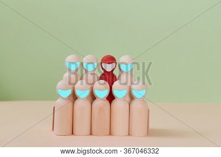 Coronavirus Outbreak. Covid-19. Novel Sars-cov2. Group Of Wooden Figures With One Infected. Miniatur