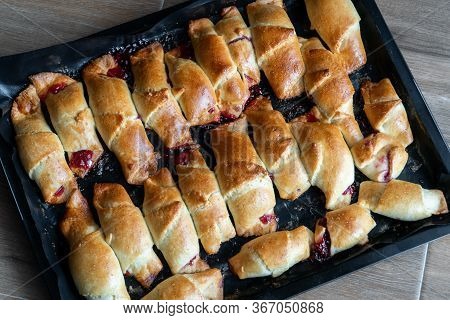 Pies With Jam On A Baking Sheet. Cakes With Jam On Baking Tray On Wooden Table. Homemade Baking Reci