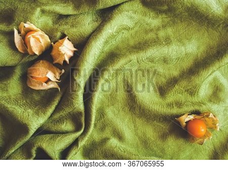 Sweet Yellow Physalis Berry Fruit On Dright Warm Green Drapery. Can Be Used As Slide Poster Card. A 