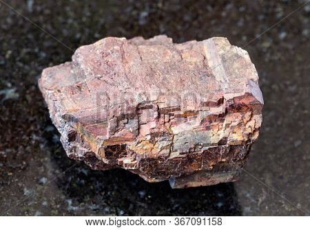 Closeup Of Sample Of Natural Mineral From Geological Collection - Raw Siderite Rock On Black Granite