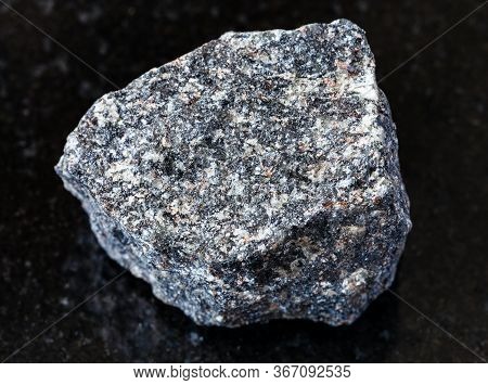 Closeup Of Sample Of Natural Mineral From Geological Collection - Rough Nepheline Syenite Rock On Bl