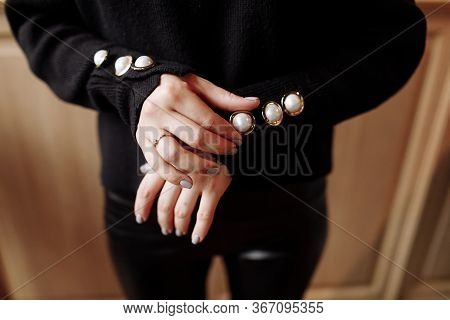 Cropped Photo Of A Stylish Woman In Black Outfit With Pearls Details. Ashion Concept