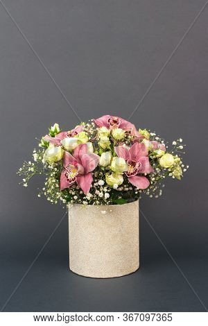 Vase With Beautiful Bouquet Of Orchids, Roses And Gypsophila, Babys-breath Flowers, On Dark Grey Bac