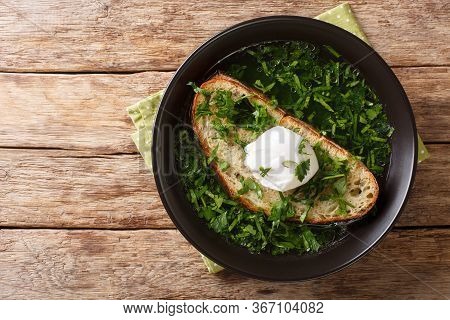 Tasty Portuguese Acorda Soup With Greens, Garlic, Bread And Poached Egg Close-up In A Plate. Horizon