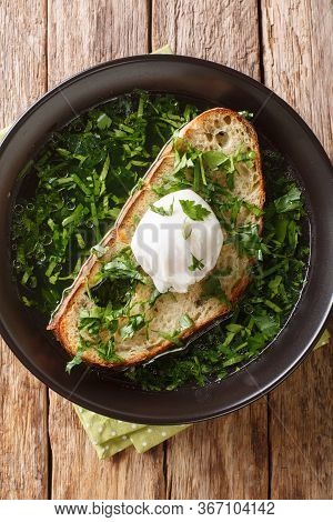 Portuguese Garlic And Cilantro Bread Soup Acorda Served With Poached Egg Close-up In A Plate. Vertic