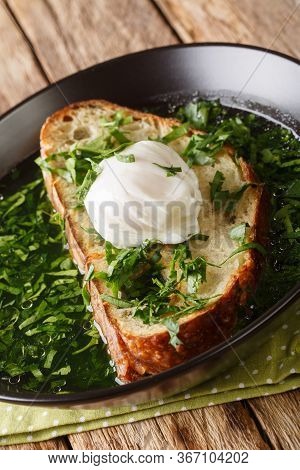 Portuguese Garlic And Cilantro Bread Soup Acorda Served With Poached Egg Close-up In A Plate. Vertic