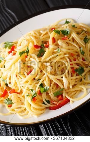 Spaghetti Aglio E Olio is A Simple Italian Dish Of Garlic, Olive Oil, Parsley Close-up In A Plate. V