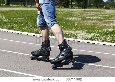 Man on roller skates in stadium in summer