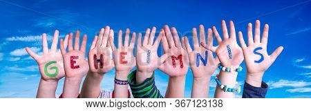 Children Hands Building Word Geheimnis Means Secret, Blue Sky