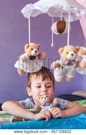 Child Holding Little Teddy Bear Toy. Little Cute Boy Holding A Soft Toy At Front Of Face Looking At 