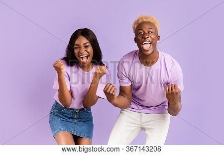 Extatic African American Couple Shouting Omg, Happy Over Victory Or Success On Lilac Background