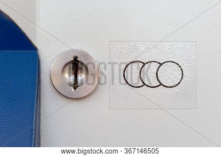 A Simple Coin Input Mechanism With A Adequate Symbol On The Side Closeup. Sideways Hole For Putting 