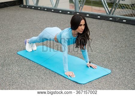 Woman doing workout alone on a roof